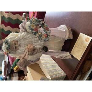 Brinn’s 1991 collectible Santa Doll with wreath and presents